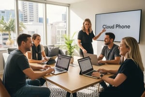 Group of professionals in a modern office discussing cloud business phone systems, with a presentation screen displaying "Cloud Phone."