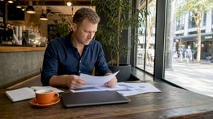 White man reviewing digital transformation plan at desk