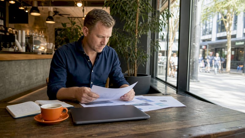 White man reviewing digital transformation plan at desk