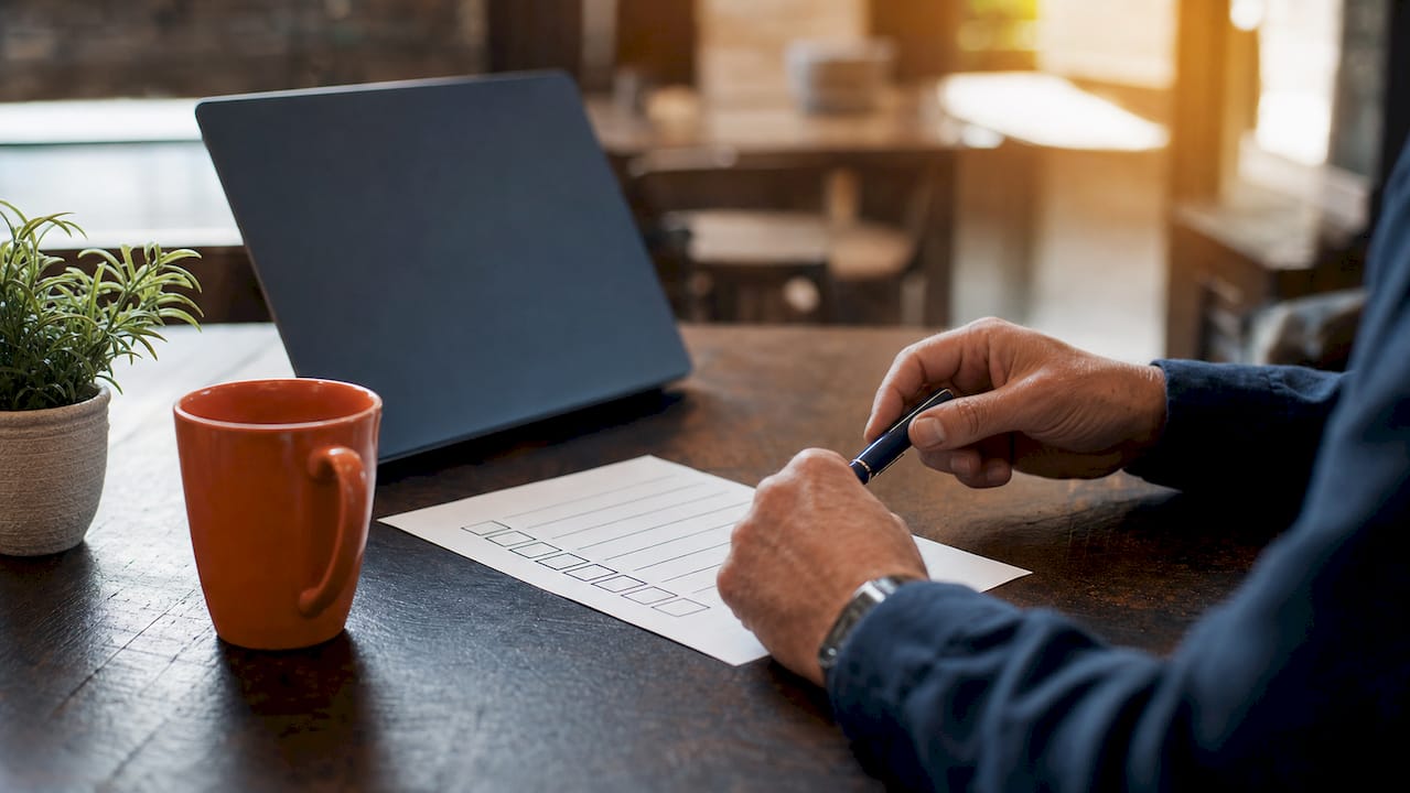 Hands reviewing security checklist on desk