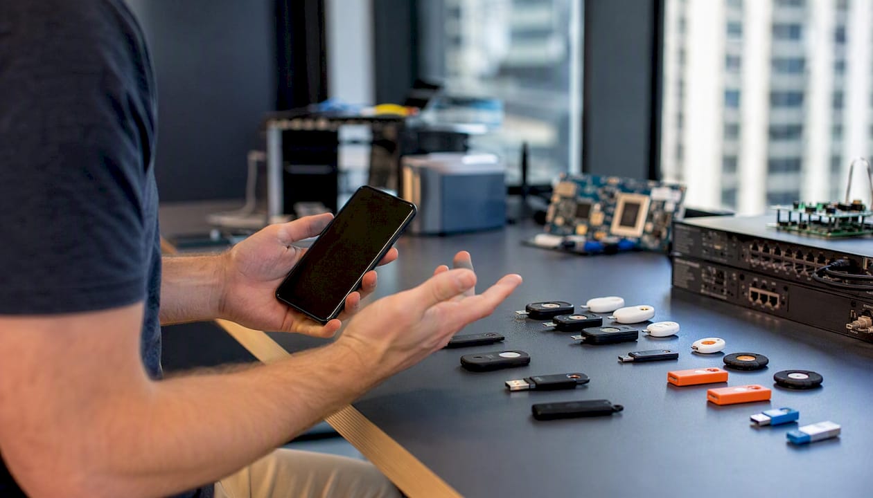 Hands managing security tokens and devices