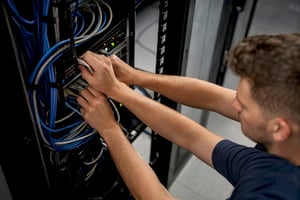 Technician hands connecting security cables in server rack