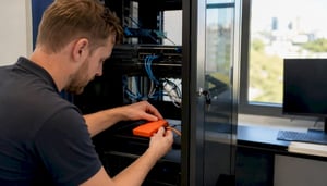 Technician wiring backup device in server room