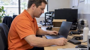 White technician provisioning a new business laptop