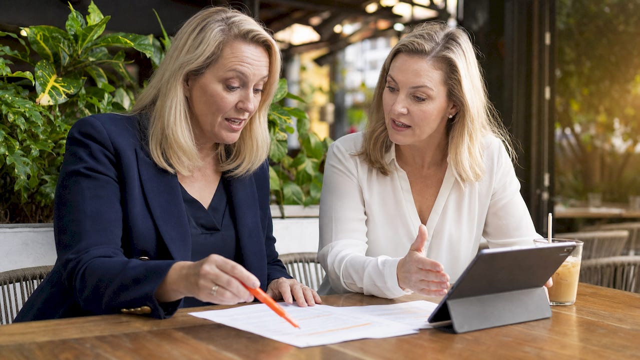 Two businesswomen discussing IT contract