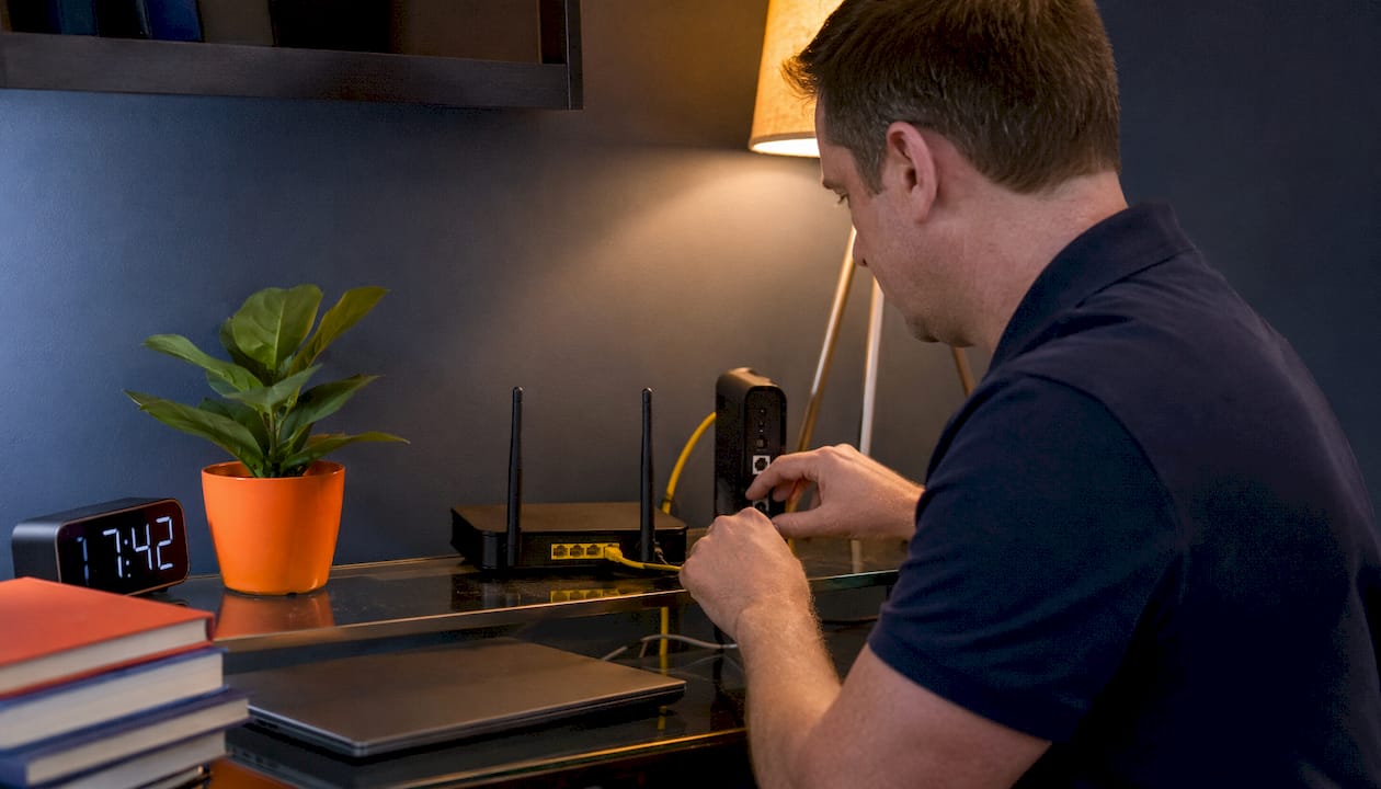 Hands managing home internet security devices